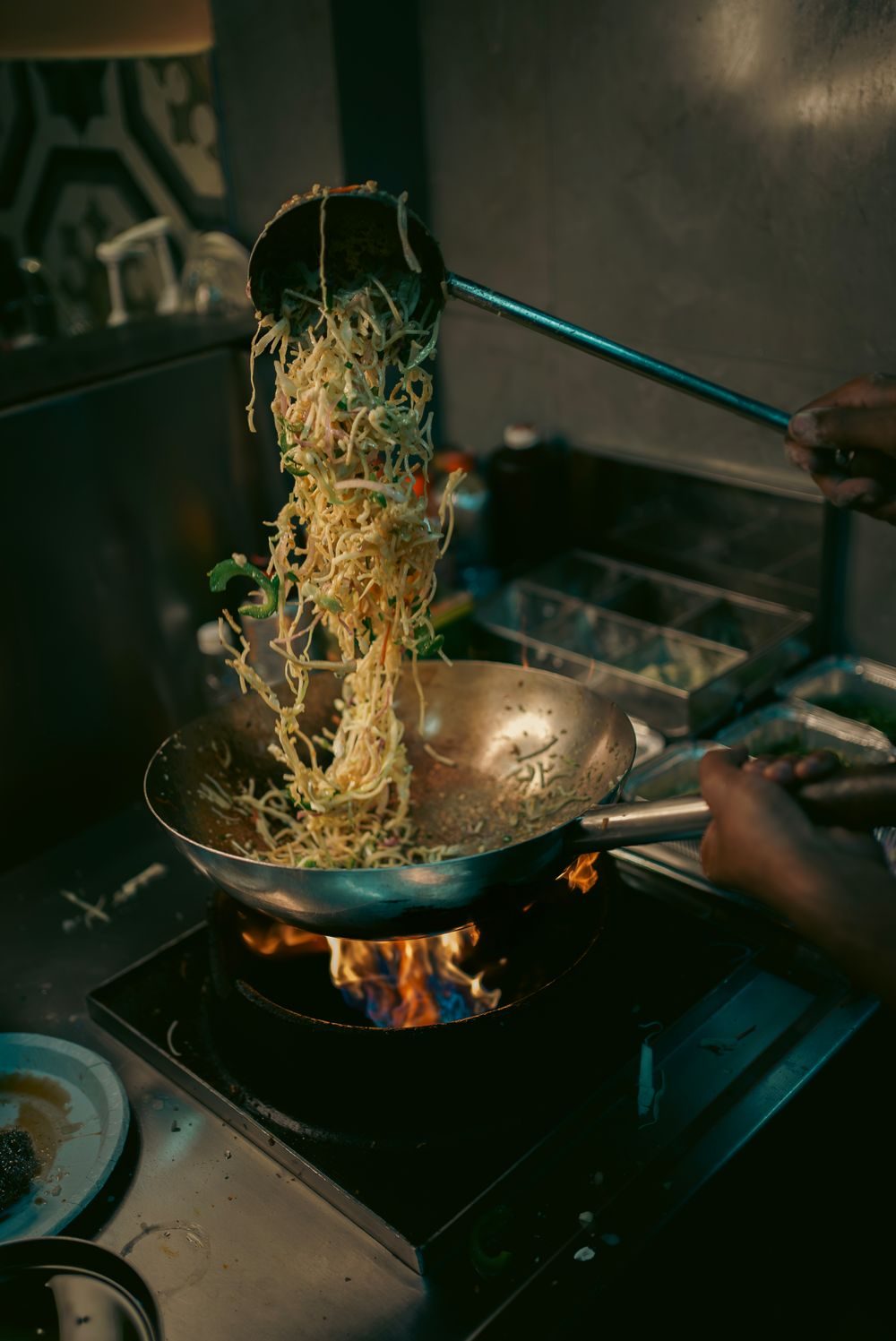 Noodles tossed in a flaming wok
